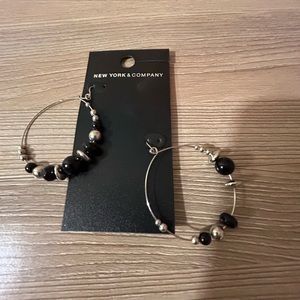 Hoop earrings with black and silver beads.